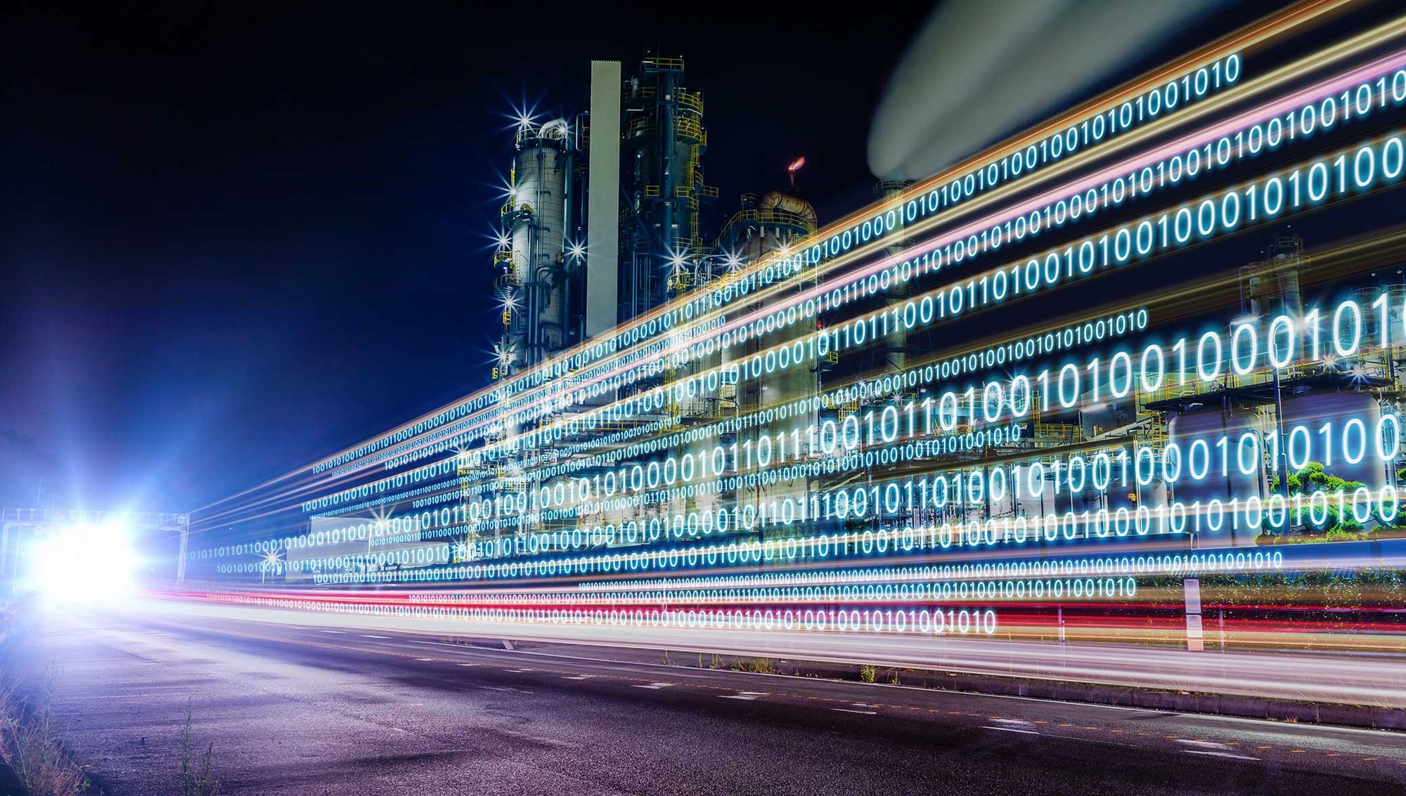 A long exposure shot capturing light trails on a road with binary code overlay and a factory at night.